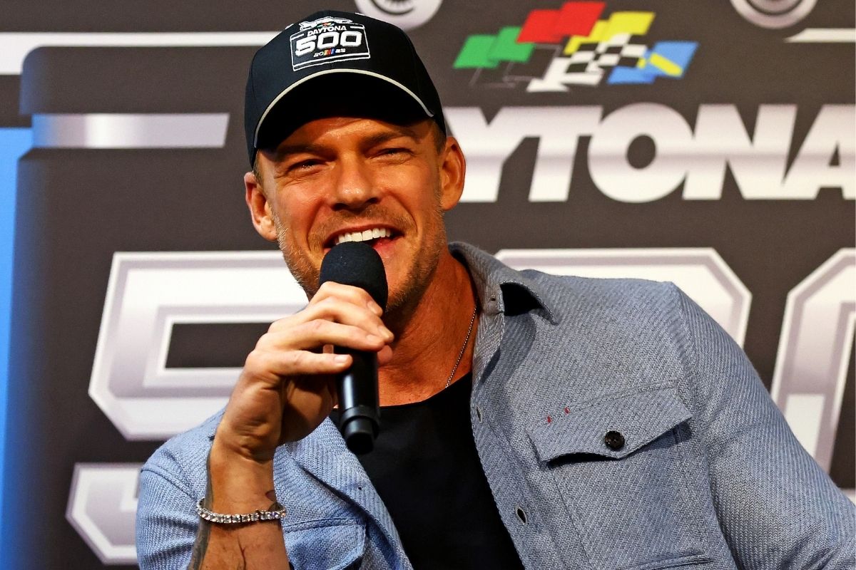 Feb 16, 2025; Daytona Beach, Florida, USA; American actor Alan Ritchson speaks during a press conference before the Daytona 500 at Daytona International Speedway.