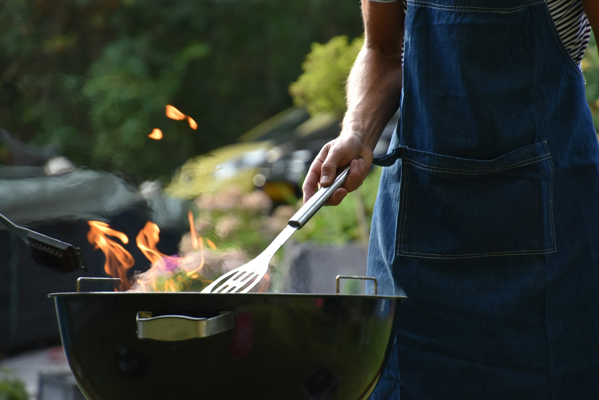 man cooking on a grill / bbq equipment at costco