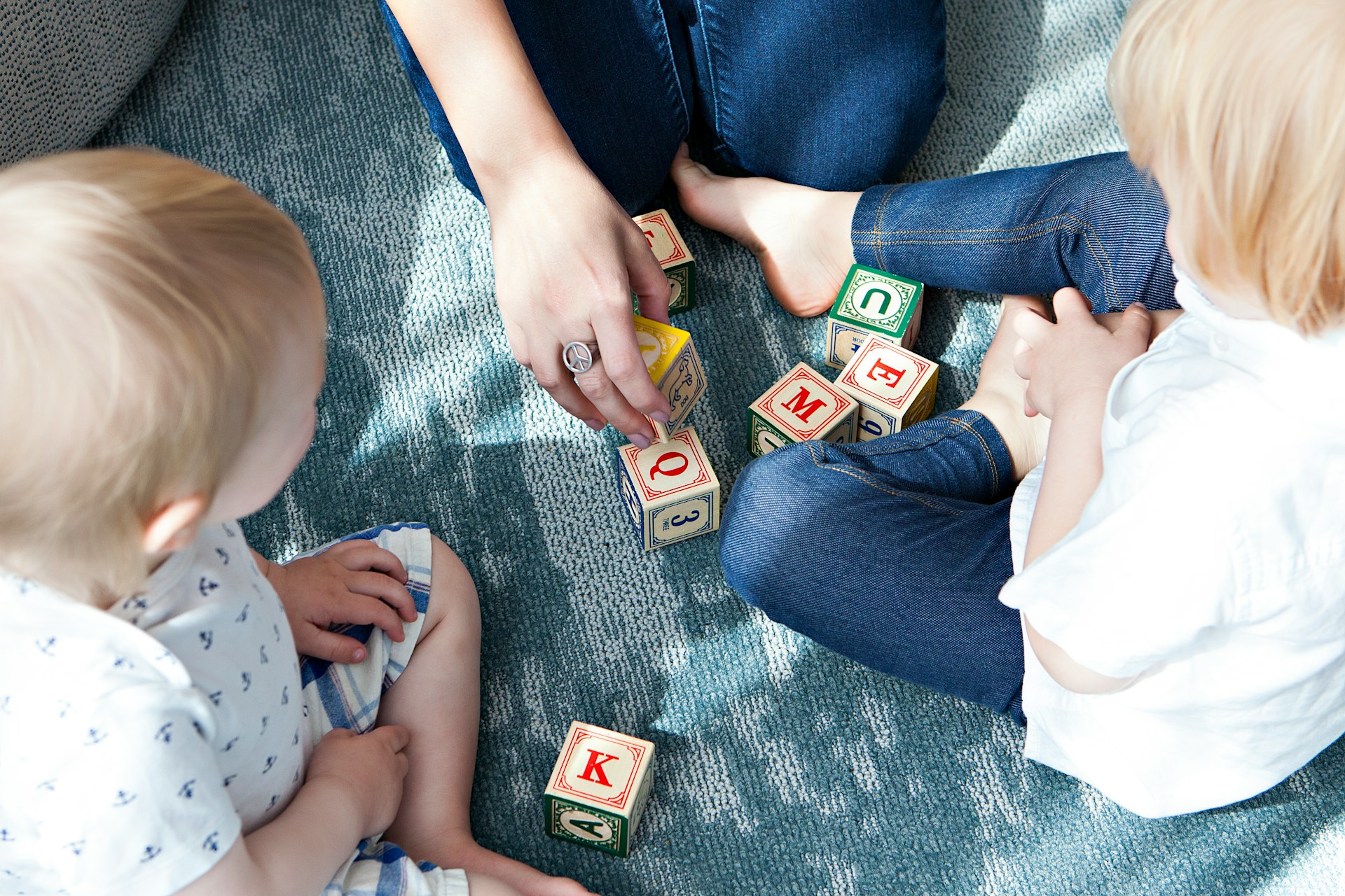 children and parent playing with blocks