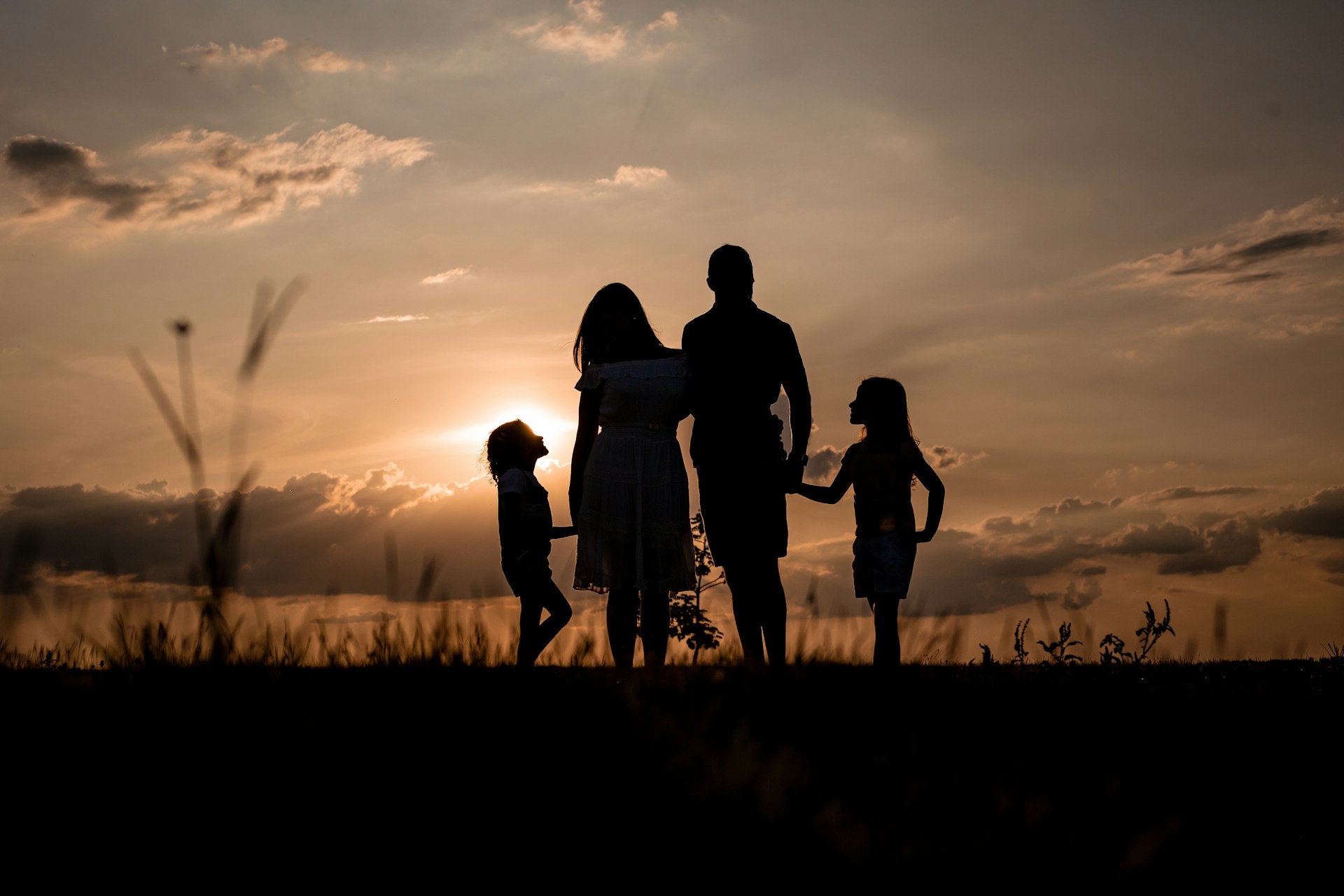 family silhouette in sunset