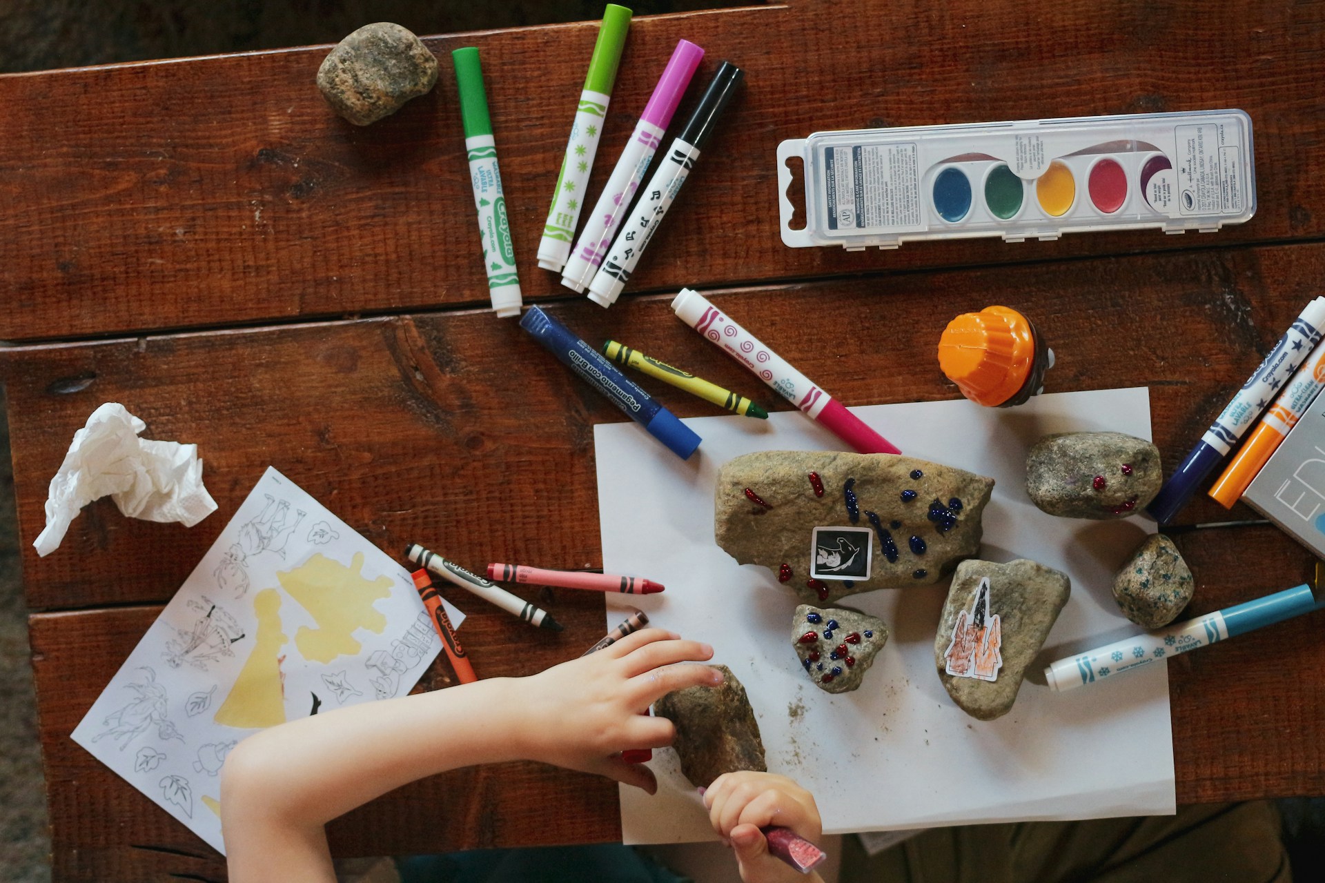 child coloring rocks