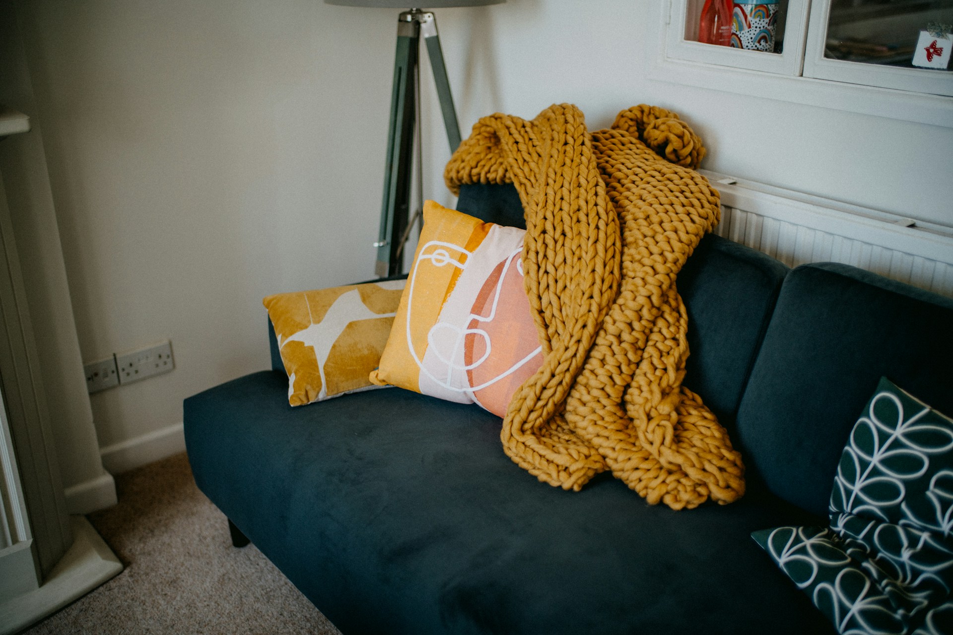 couch with pillows and blanket