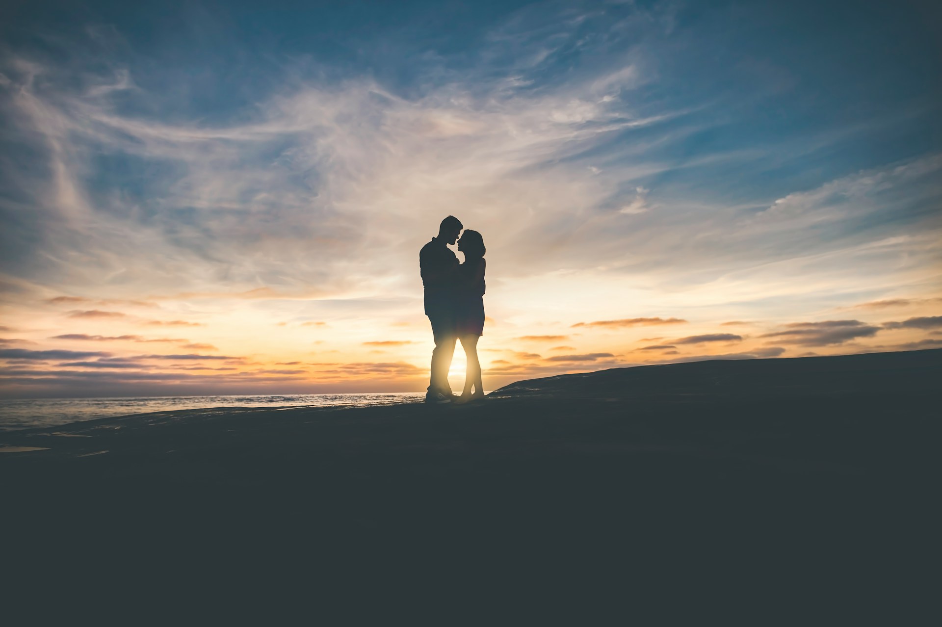 man and woman silhouette sunset