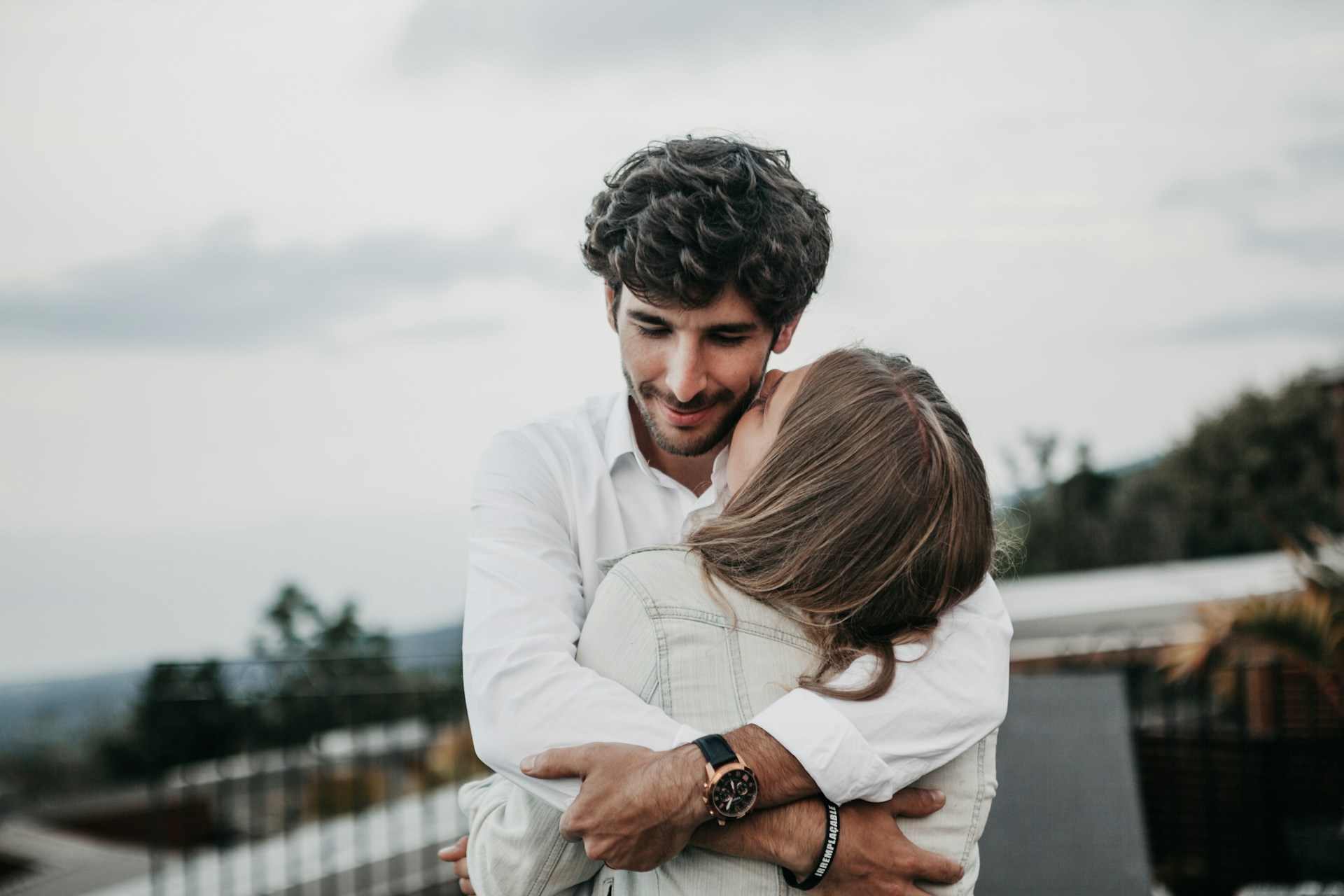 man hugging woman