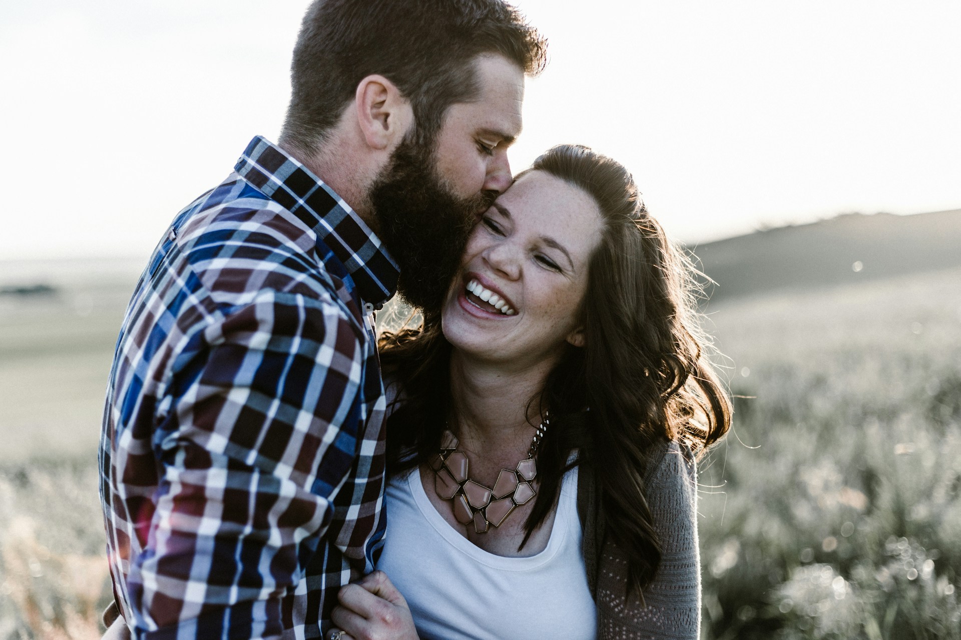 man kissing woman