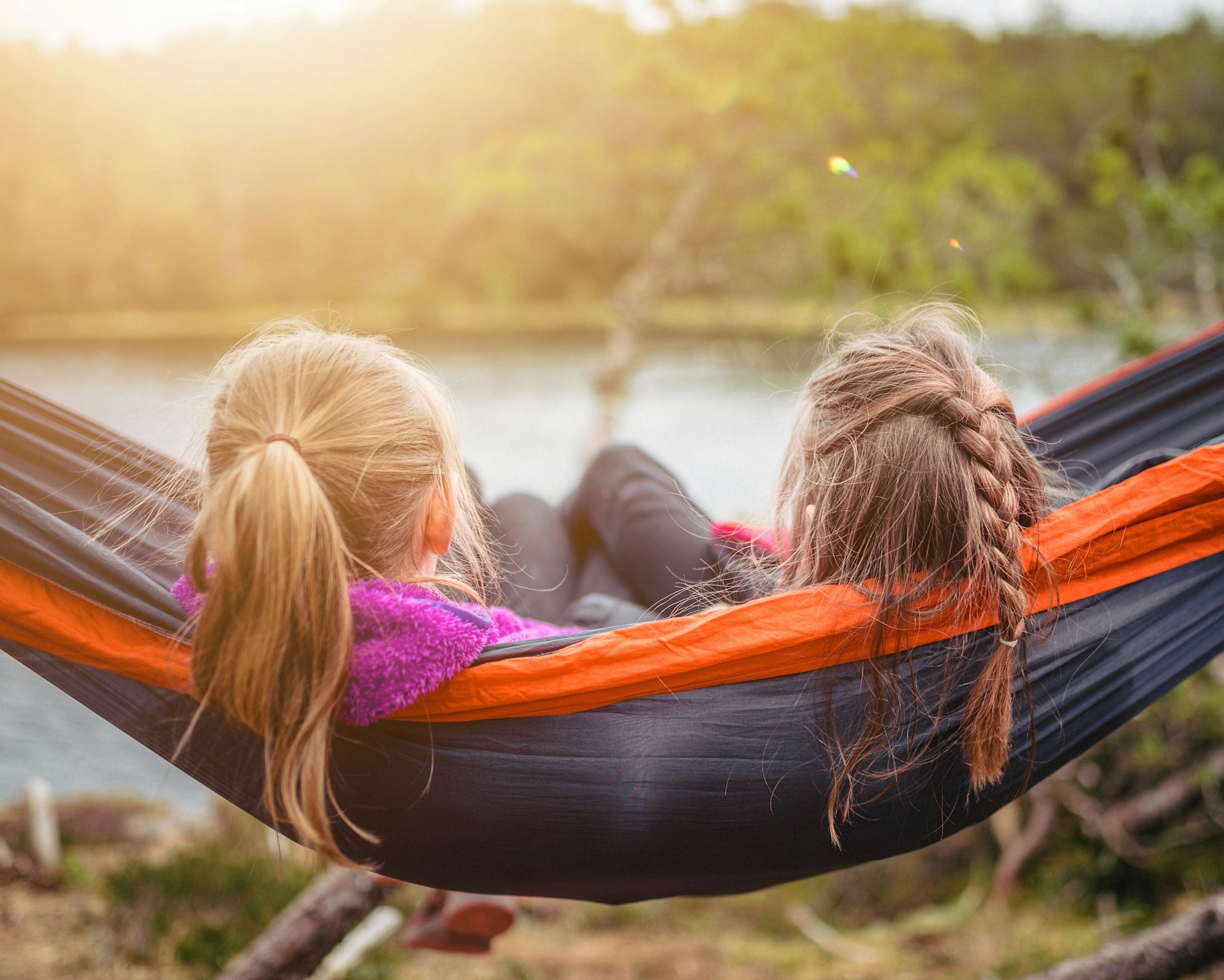 two girls sitting in a hammock