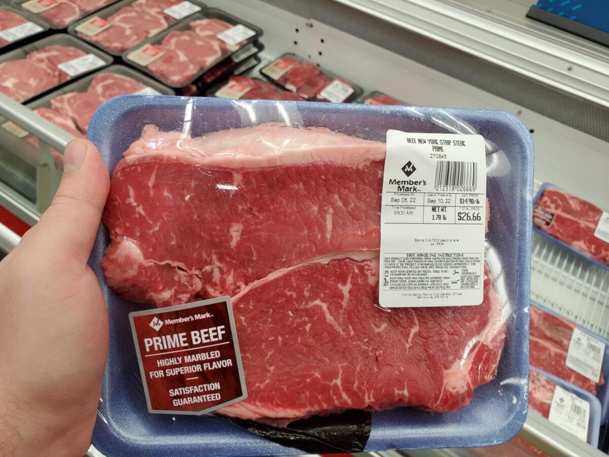 person holding sam's club steak