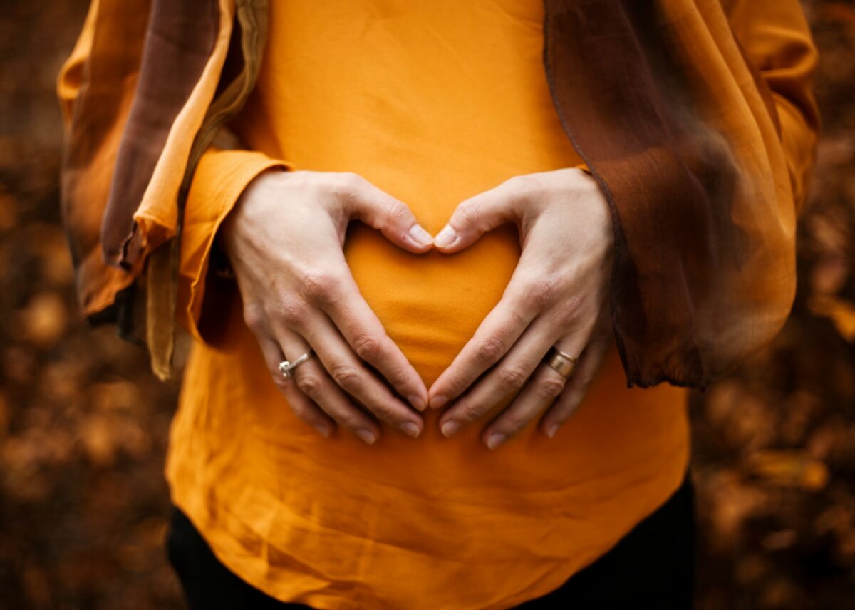 woman putting heart over stomach / gut-healthy items at costco