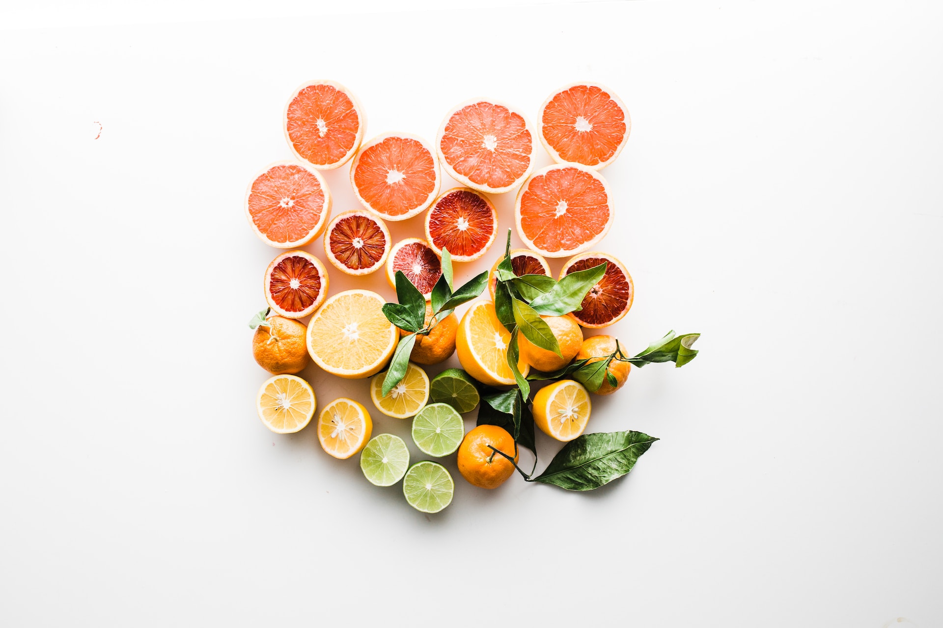 Citrus fruits arranged in a heart shape with grapefruit, oranges, lemons, and limes