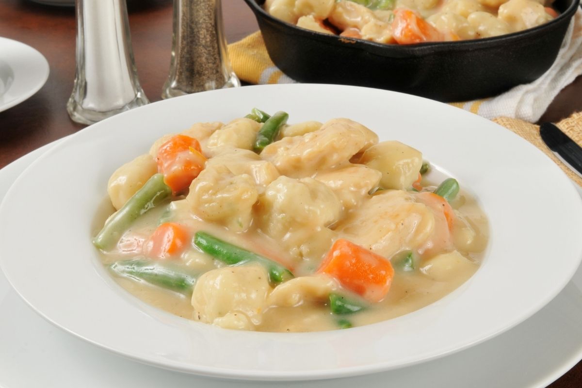 Chicken and dumplings on a plate.