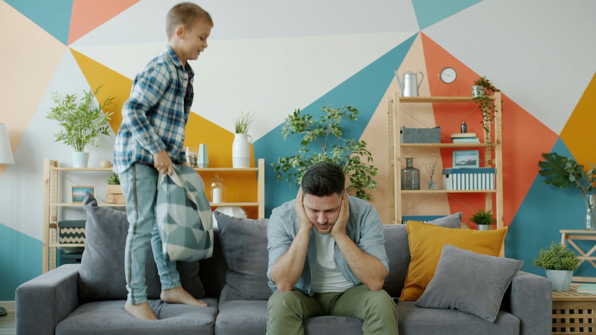 dad covering ears with child