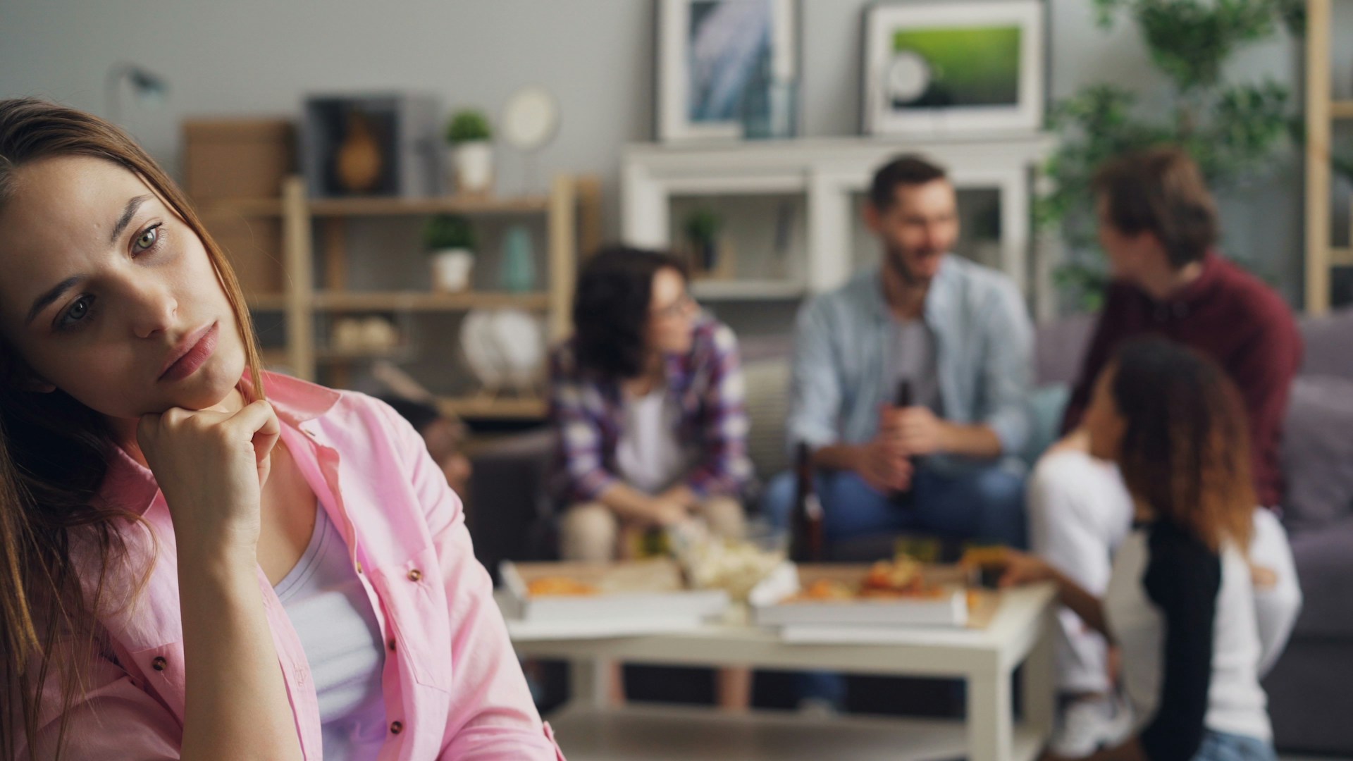 woman sitting away from family