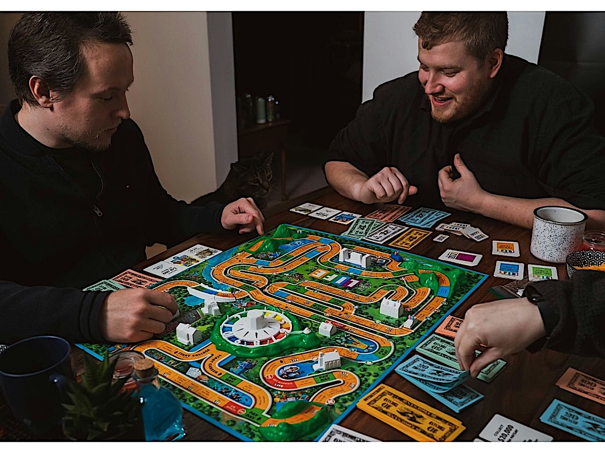 Friends playing board game "Life"