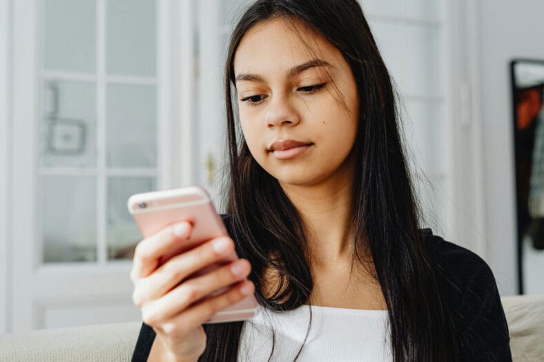 Teenager on smart phone looking at social media