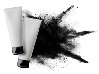 face wash tubes with charcoal splatter
