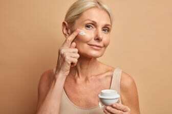 woman applying moisturizer