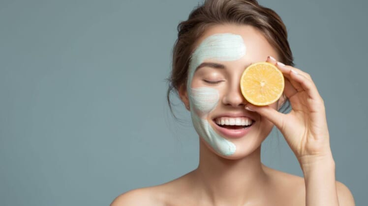 woman with lemon and face mask