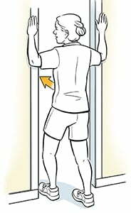 Woman standing in doorway doing pectoral stretch exercise. stretches for sitting all day