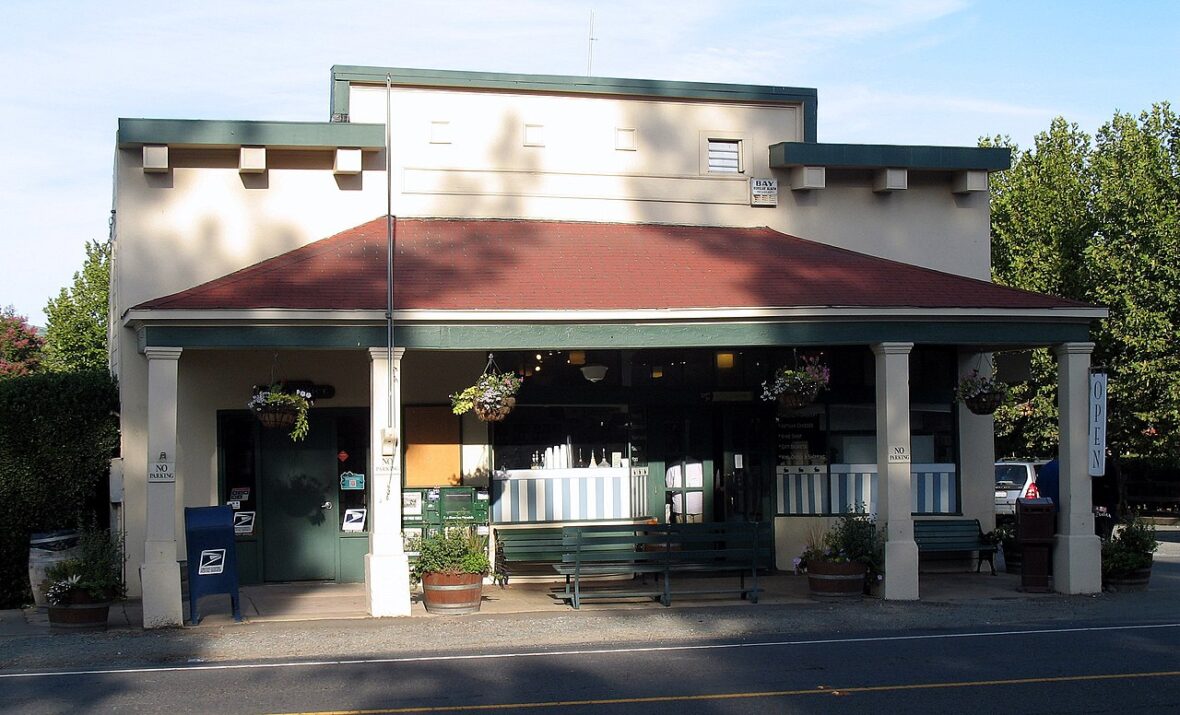 A historic storefront with a red awning and white columns in downtown Healdsburg