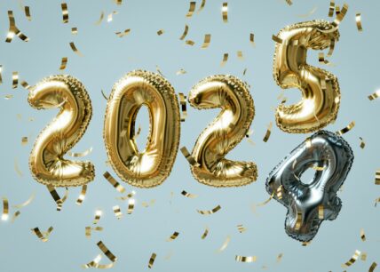 Gold and silver balloons displaying 2025 with falling confetti on blue background