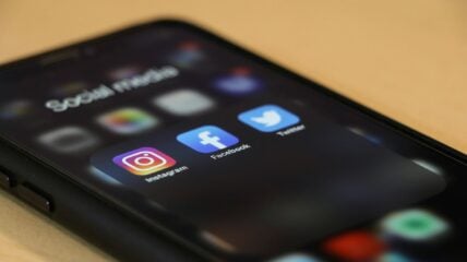 Smartphone screen displaying Instagram, Facebook, and Twitter app icons