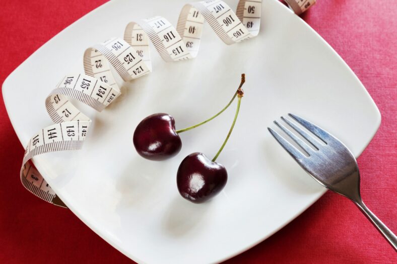 cherries on plate with measuring tape