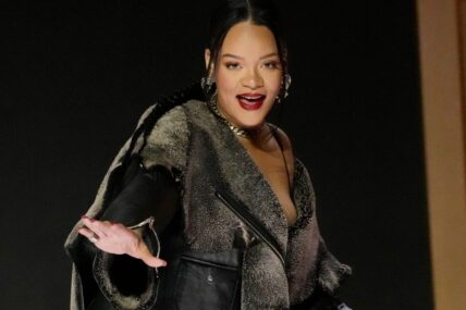 Apple Music Super Bowl LVII Halftime Show talent Rihanna is helped off the stage at a news conference in Phoenix on Feb. 9, 2023.