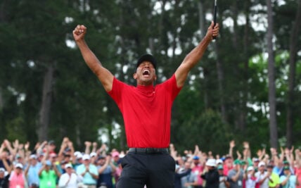 Tiger Woods celebrates after making a putt on the 18th green to win The Masters golf tournament at Augusta National Golf Club on