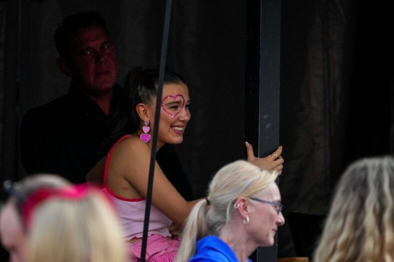 Actress Millie Bobby Brown watches from a VIP tent before Taylor Swift performers during the first night of the Cincinnati stop