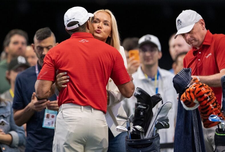 Tiger Woods of Jupiter Links GC gets a hug and kiss from Vanessa Trump before match against Los Angeles Golf Club during the TGL