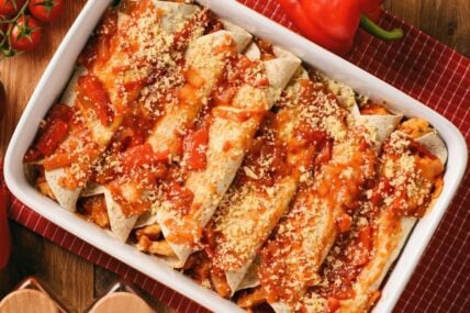 Chicken Enchiladas, tortilla with chicken, cheese, tomatoes and spices.