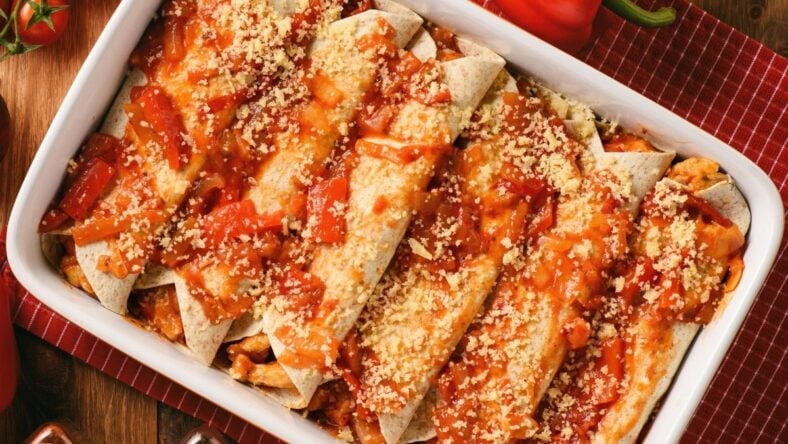 Chicken Enchiladas, tortilla with chicken, cheese, tomatoes and spices.